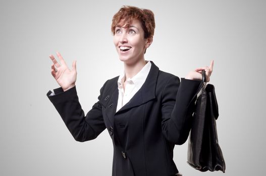 happy business woman with briefcase on gray background