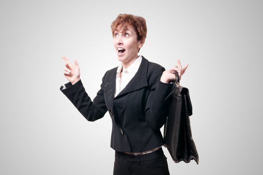 astonished business woman with briefcase on gray background