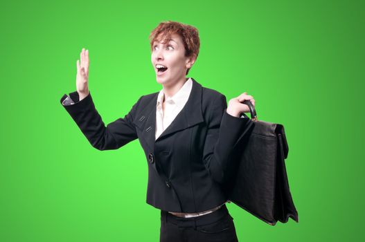 astonished business woman with briefcase on green background