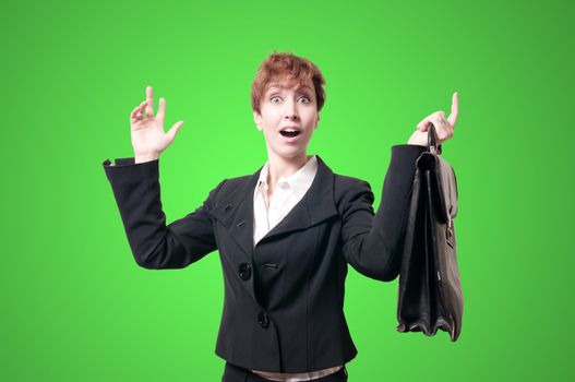 astonished business woman with briefcase on green background