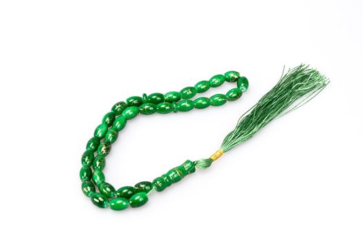 green rosary beads on white background