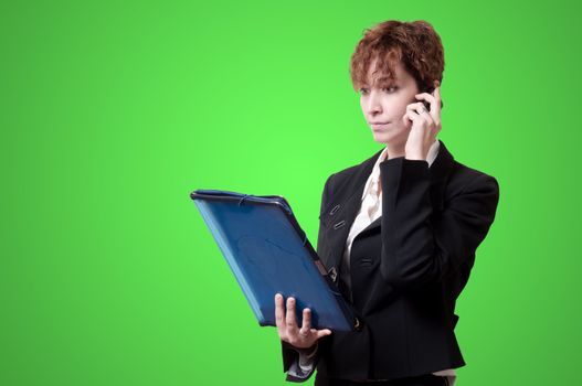 success business woman with briefcase and phone on green background