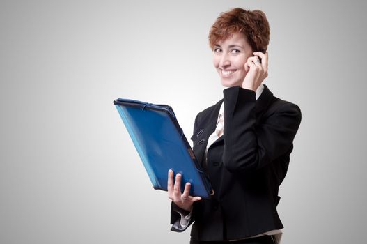 success business woman with briefcase and phone on gray background