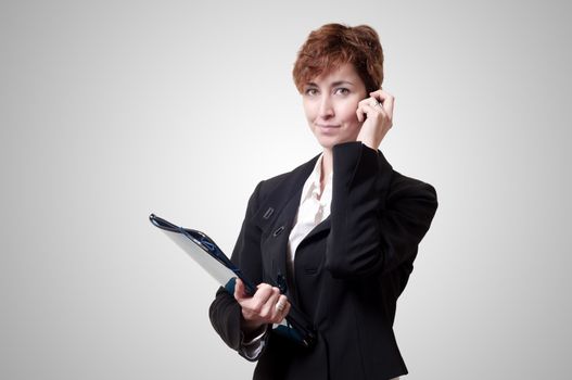 success business woman with briefcase and phone on gray background