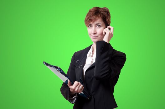 success business woman with briefcase and phone on green background