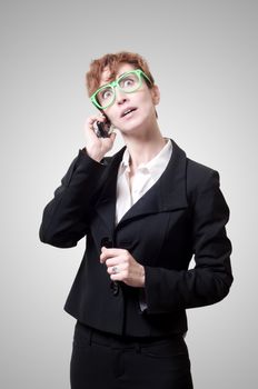 business woman calling on phone on gray background