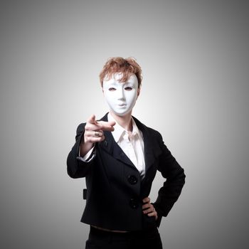 business girl pointing with white mask on gray background