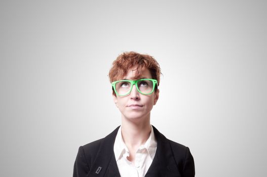 business woman with green eyeglasses on gray background
