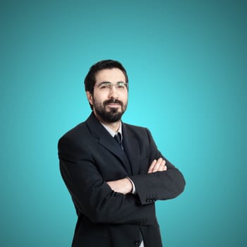 elegant bearded success business man on blue background