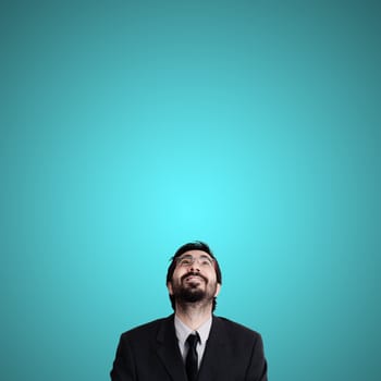 bearded business man looking up on blue background