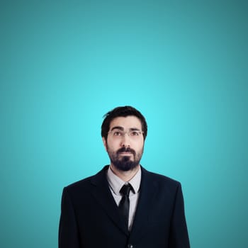 bearded business man looking up on blue background