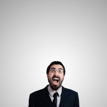 bearded business man looking up on gray background