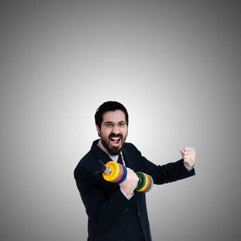 strong business man with weight gym on gray background