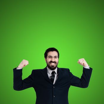 strong business man flexing muscle on green background