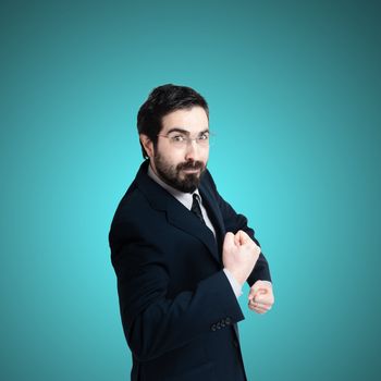 strong business man flexing muscle on blue background