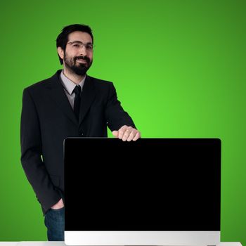 business man and pc monitor on green background