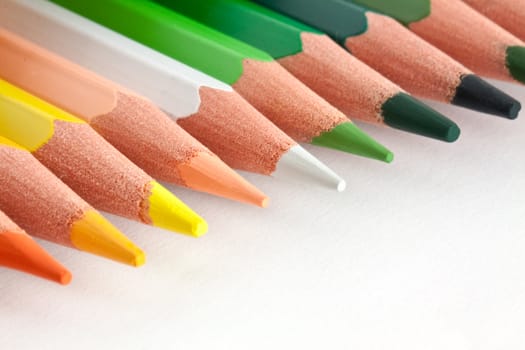 Row of color pencils isolated on white