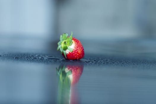 fresh strawberry in drop of water