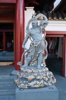 SINGAPORE - JUNE 27: Guardian of the Buddha Tooth Relic Temple door in the Chinatown district of Singapore, June 27, 2009. The temple is built to house the tooth relic of the historical Buddha. Design is based on the Tang dynasty architectural style. Construction started on 13 March 2005 and officially Opened on 30 May 2007.