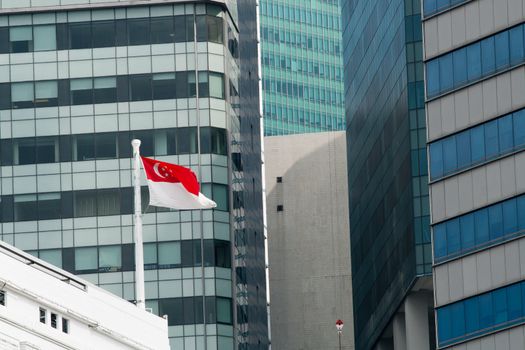 Flag of the Republic of Singapore against office windows