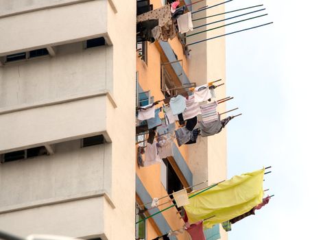 Laundry hanging out of window to dry. Singapore residential apartments.