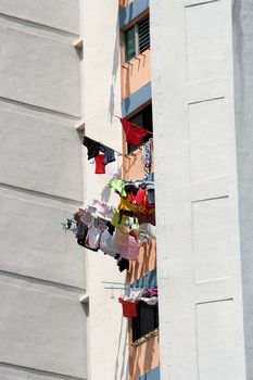Laundry hanging out of window to dry. Singapore residential apartments.