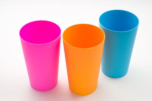 Three color plastic cup on white table