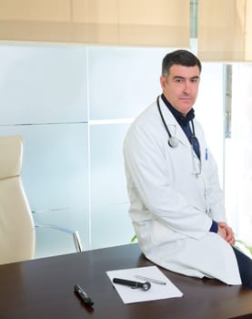 Doctor man expertise portrait casual sitting in hospital office desk