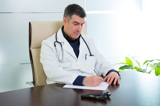 Doctor man expertise sitting in hospital office desk portrait