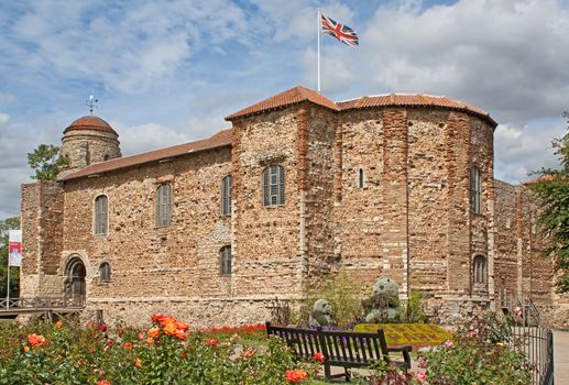 11th century Norman castle in Colchester in springtime and UK flag.