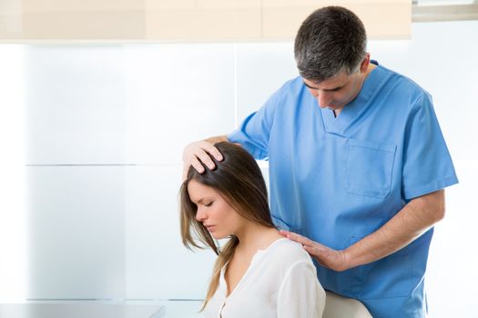 physiotherapist doing myofascial therapy on woman patient in hospital