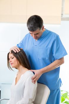 physiotherapist doing myofascial therapy on woman patient in hospital