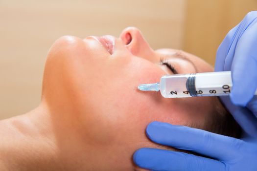 Anti aging facial mesotherapy with syringe closeup on woman face