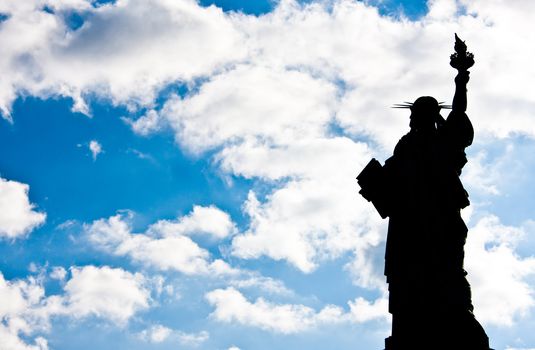 Sunnny day, blue sky with clouds: statue of Liberty with copy space