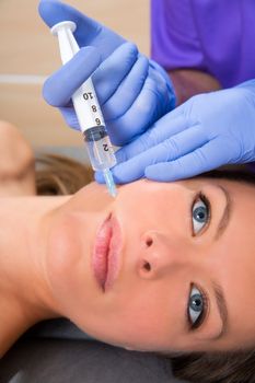 Anti aging facial mesotherapy with syringe closeup on woman face