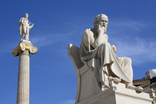 Neoclassical statues of Socrates (Greek ancient philosopher) and Apollo (god of  the sun, medicine and the arts) in front of the Academy of Athens, Greece.