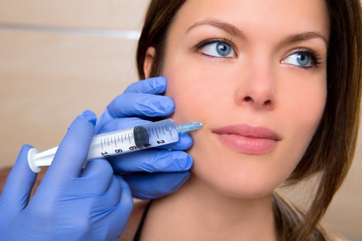 Anti aging facial mesotherapy with syringe closeup on woman face rictus
