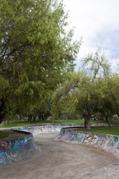 Skateboarding with graffiti in the public gardens in Quito