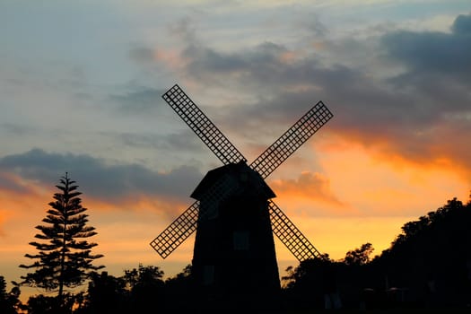 Silhouettes of windmill at sunset, at Thailand 