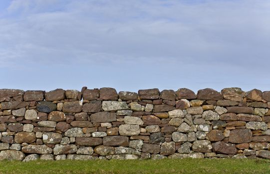 scottish stone wall in evening light. detail shot. vertical image