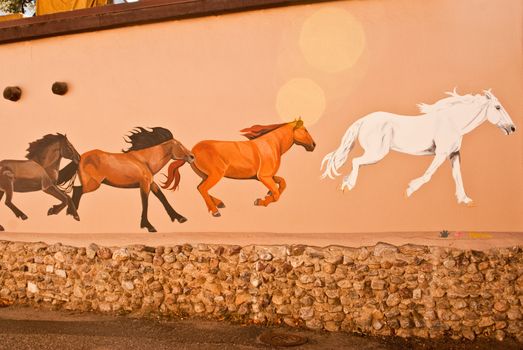 TAOS, NEW MEXICO/USA - OCTOBER 20: Mural depicting wild painted horses on walls of old town shown on October 20, 2011 in Taos, New Mexico. Taos is world famous for arts and culture.