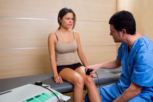 Ultrasonic therapy machine treatment doctor and woman patient on her knee