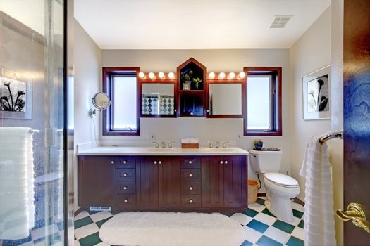 Bathroom with shower, dark wood cabinet, square tiles.