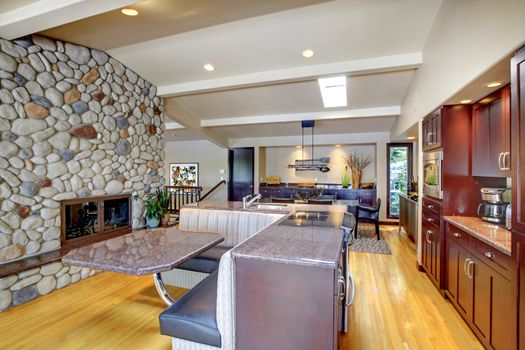 Luxury mohogany Kitchen with modern furniture and stone fireplace.