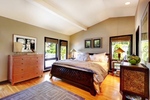 Modern luxury bedroom with bed, dresser and nightstand.