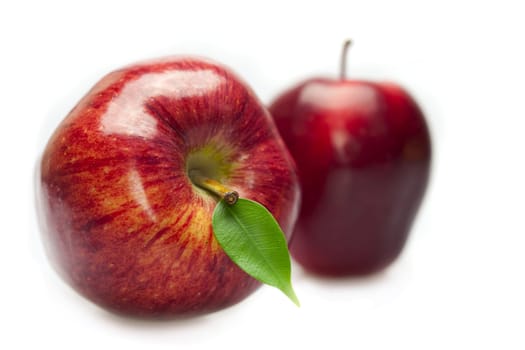 red apples with leaves isolated on white