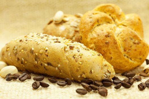 bun with coffee beans on linen fabric