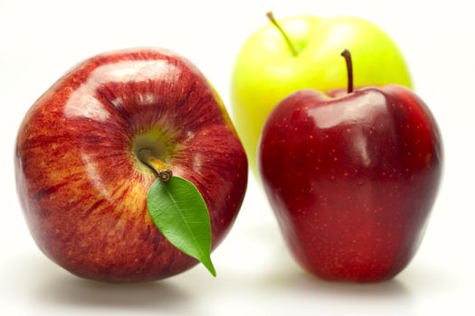 apples with green leaves isolated on white