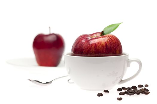 apples in a bowl, spoon and coffee beans isolated on white