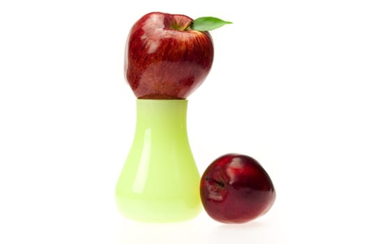 apples with green leaves  in the vase   isolated on white